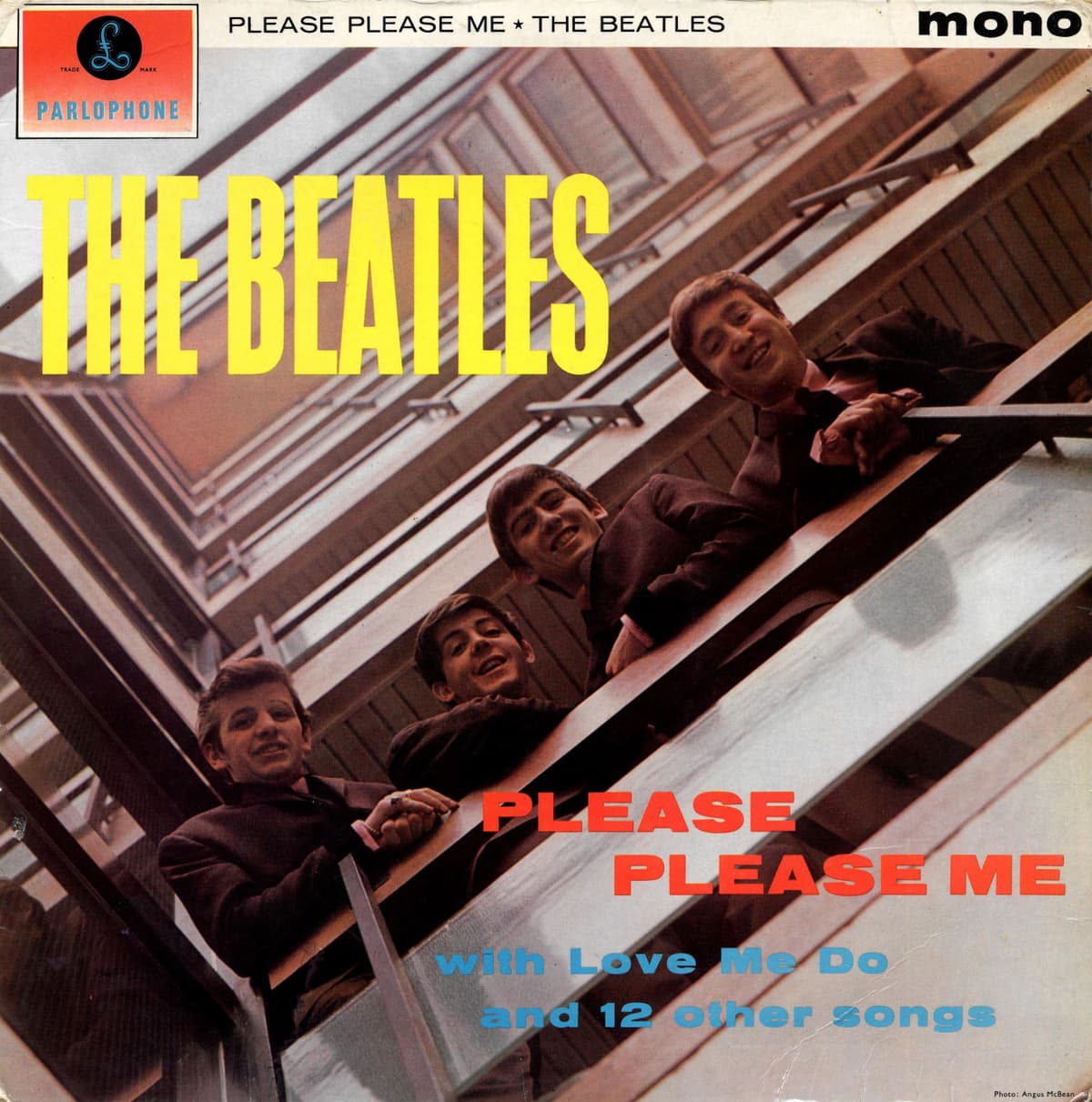 Please Please Me by The Beatles album cover — John Lennon, Paul McCartney, George Harrison and Ringo Starr lean over an interior balcony at EMI House in Manchester Square,…